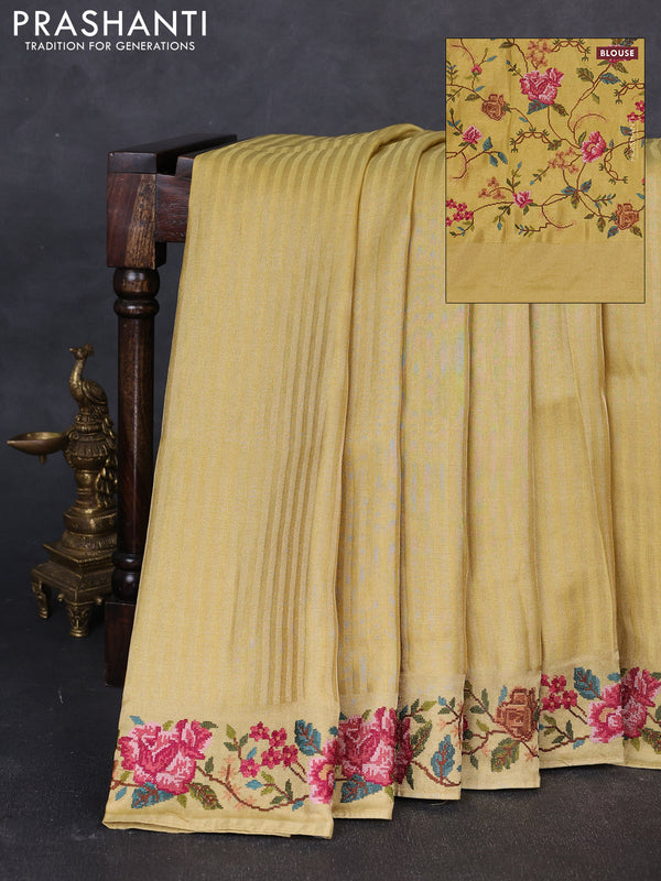 Tissue saree yellow with allover zari stripe pattern and embroidery border