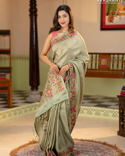 Tissue saree pastel green with allover zari stripe pattern and embroidery border