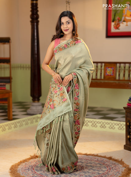 Tissue saree pastel green with allover zari stripe pattern and embroidery border