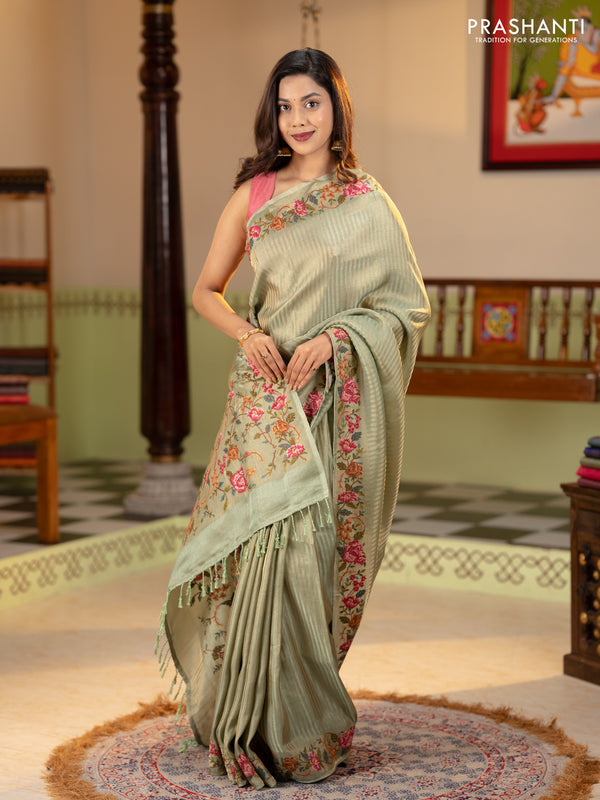 Tissue saree pastel green with allover zari stripe pattern and embroidery border