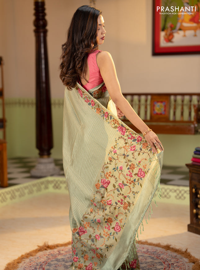 Tissue saree pastel green with allover zari stripe pattern and embroidery border
