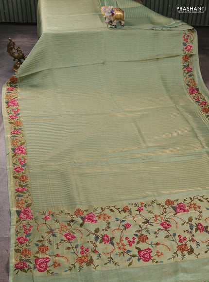 Tissue saree pastel green with allover zari stripe pattern and embroidery border