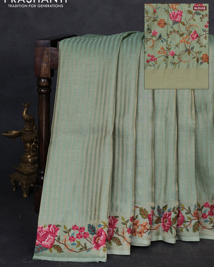 Tissue saree pastel green with allover zari stripe pattern and embroidery border