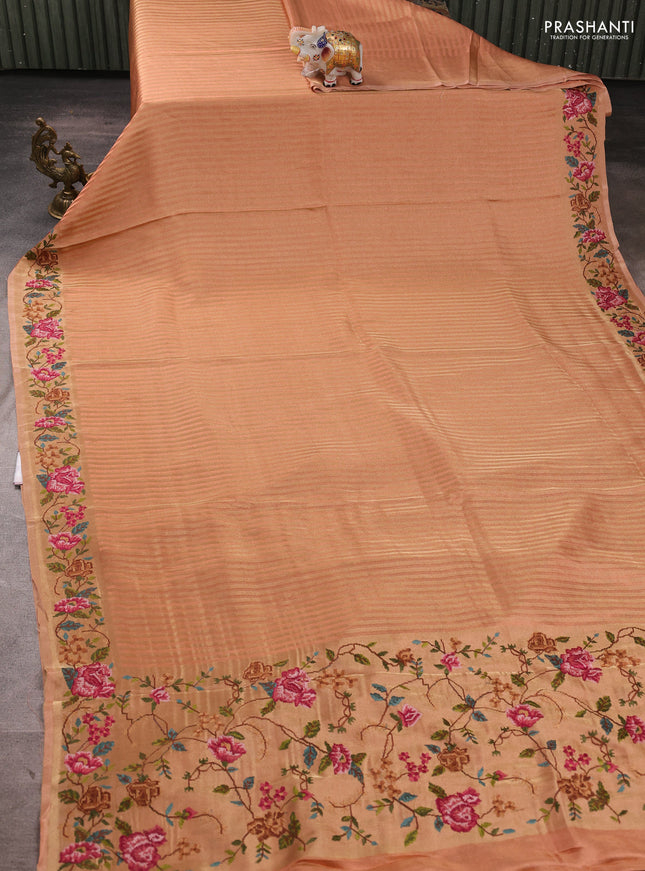 Tissue saree peach with allover zari stripe pattern and embroidery border