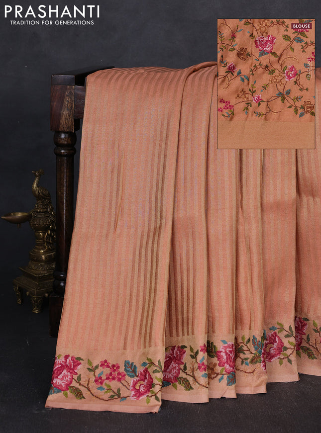 Tissue saree peach with allover zari stripe pattern and embroidery border