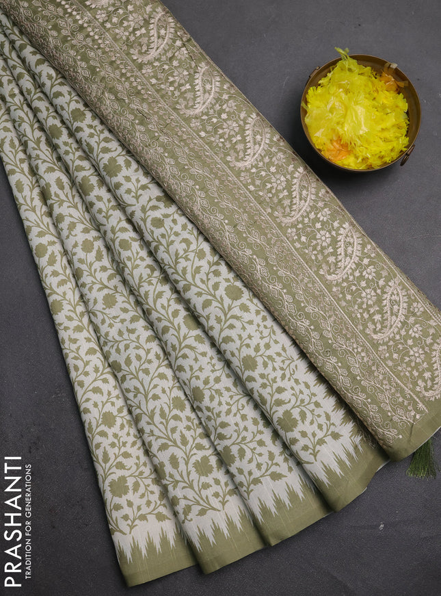 Art tussar saree cream and mehendi green with allover prints and embroidery pallu