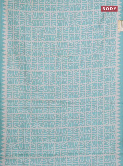 Art tussar saree cream and teal green with allover ikat prints and embroidery pallu