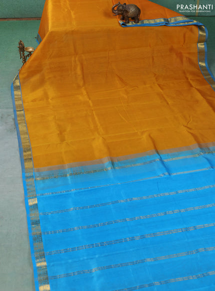 Silk cotton saree mustard yellow and cs blue with plain body and zari woven border