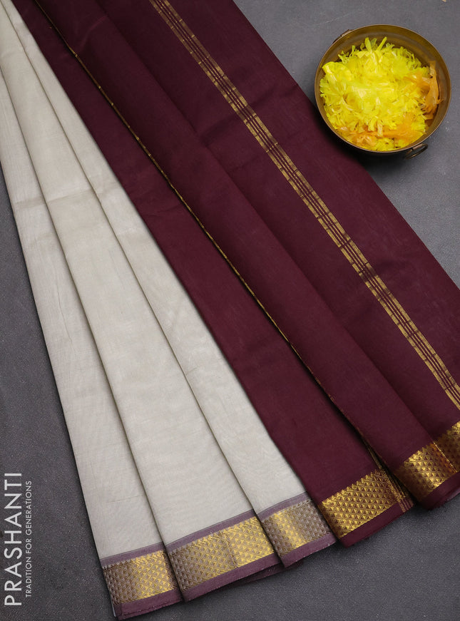 Silk cotton saree pastel grey and deep wine shade with plain body and zari woven border