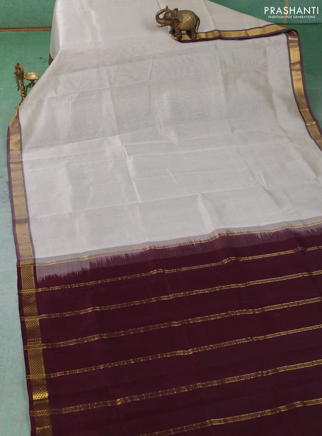 Silk cotton saree pastel grey and deep wine shade with plain body and zari woven border
