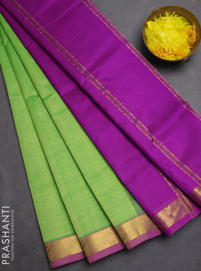 Silk cotton saree light green and purple with plain body and zari woven border