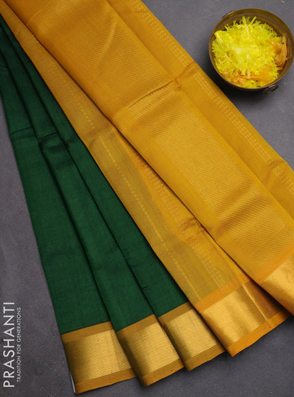 Silk cotton saree bottle green and mustard yellow with plain body and zari woven border