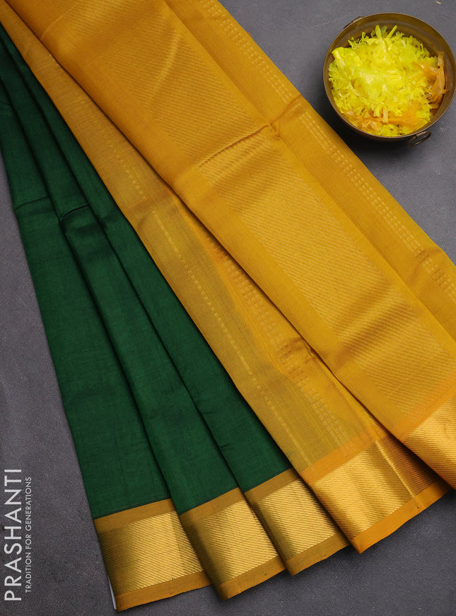Silk cotton saree bottle green and mustard yellow with plain body and zari woven border