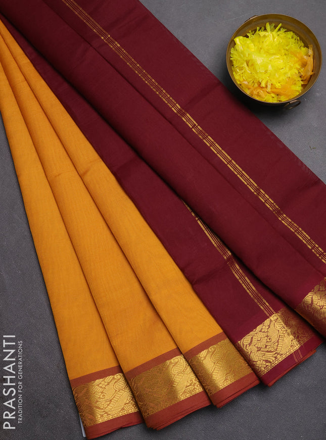 Silk cotton saree mustard yellow and deep maroon with plain body and zari woven border