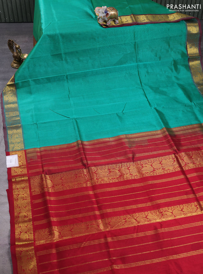 Silk cotton saree teal green and maroon with plain body and zari woven border