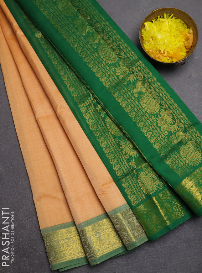 Silk cotton saree pale orange and green with plain body and zari woven border