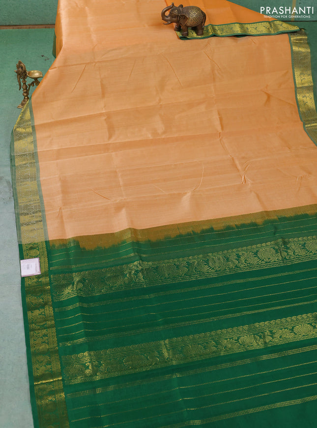 Silk cotton saree pale orange and green with plain body and zari woven border