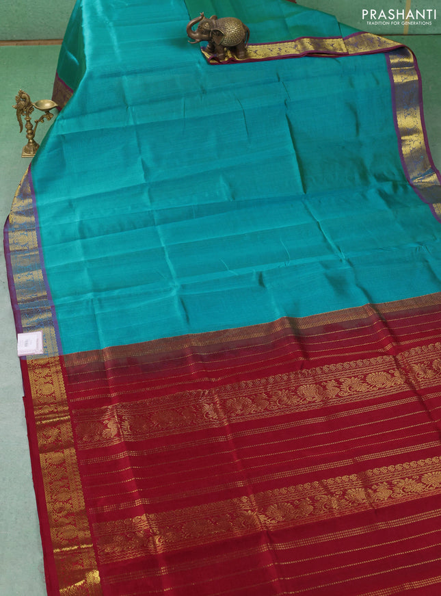 Silk cotton saree teal blue and maroon with plain body and zari woven border