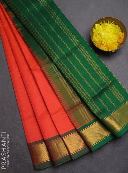 Silk cotton saree orange and green with plain body and zari woven border