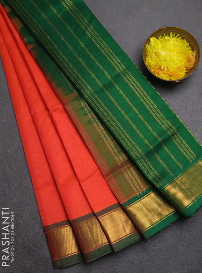 Silk cotton saree orange and green with plain body and zari woven border