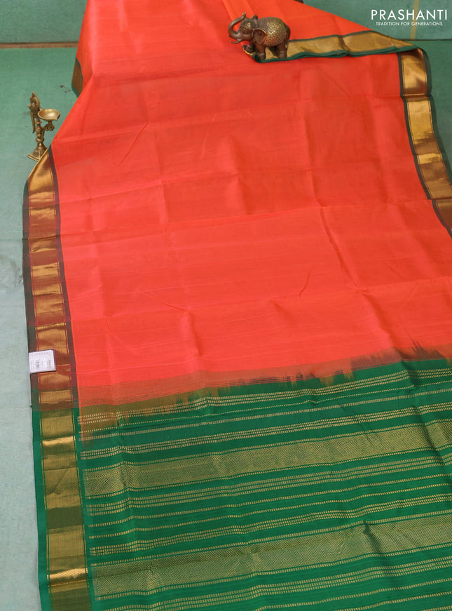 Silk cotton saree orange and green with plain body and zari woven border
