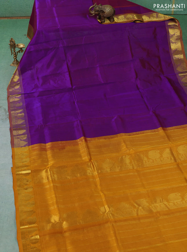 Silk cotton saree purple and mustard yellow with plain body and paisley & temple zari woven border