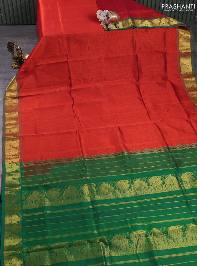 Silk cotton saree rust shade and green with plain body and paisley & temple zari woven border