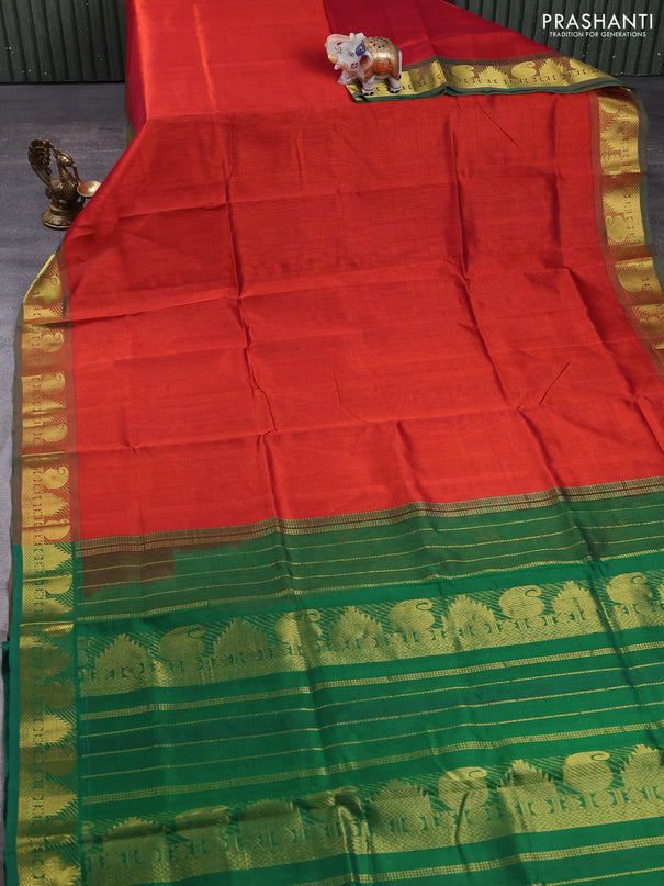 Silk cotton saree rust shade and green with plain body and paisley & temple zari woven border