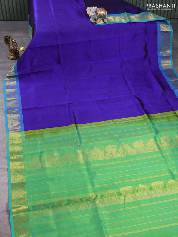 Silk cotton saree royal blue and teal green with plain body and paisley & temple zari woven border