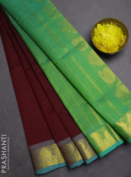 Silk cotton saree deep maroon and teal green with plain body and paisley & temple zari woven border