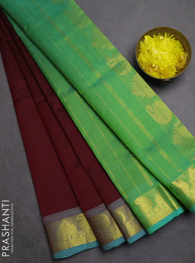 Silk cotton saree deep maroon and teal green with plain body and paisley & temple zari woven border