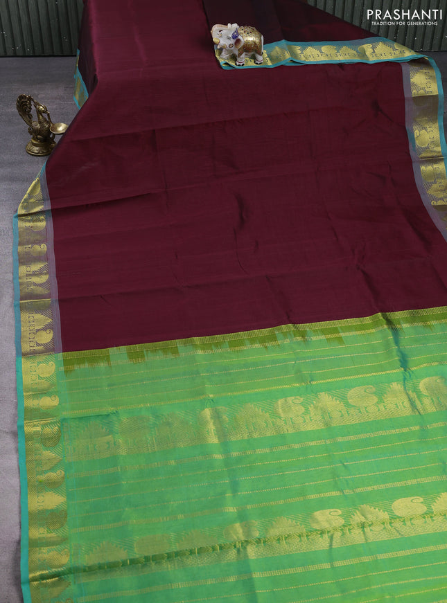 Silk cotton saree deep maroon and teal green with plain body and paisley & temple zari woven border