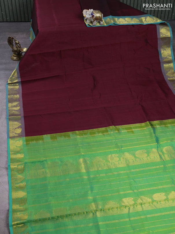 Silk cotton saree deep maroon and teal green with plain body and paisley & temple zari woven border