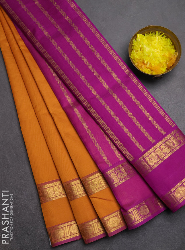 Silk cotton saree dark mustard and purple with plain body and rettapet zari woven border