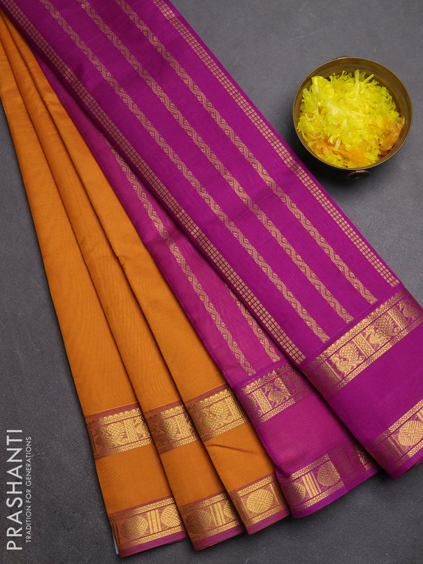 Silk cotton saree dark mustard and purple with plain body and rettapet zari woven border