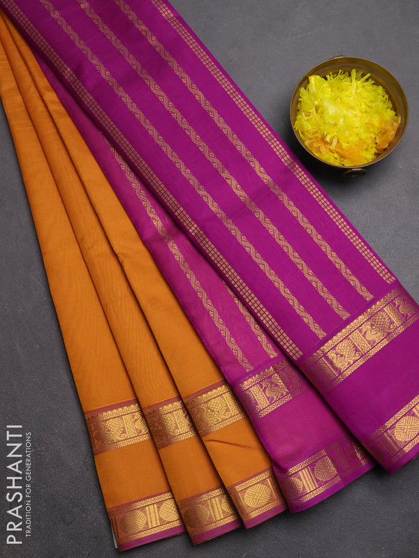 Silk cotton saree dark mustard and purple with plain body and rettapet zari woven border
