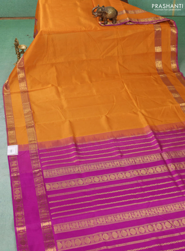 Silk cotton saree dark mustard and purple with plain body and rettapet zari woven border