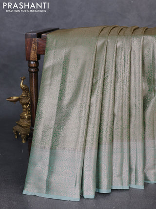 Bangalori tissue silk saree teal green with allover zari woven brocade weaves and zari woven border