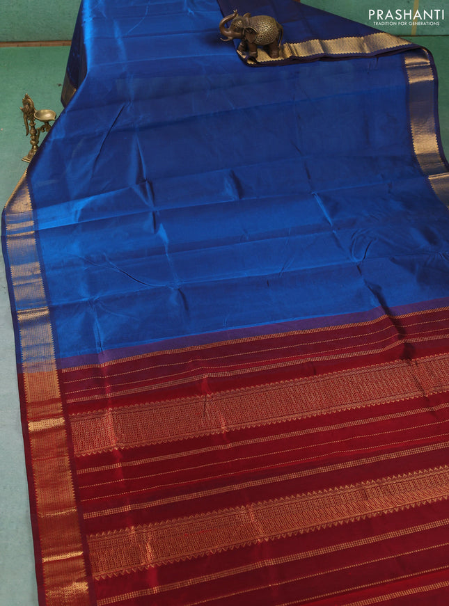 Silk cotton saree peacock blue and maroon with plain body and temple zari woven border