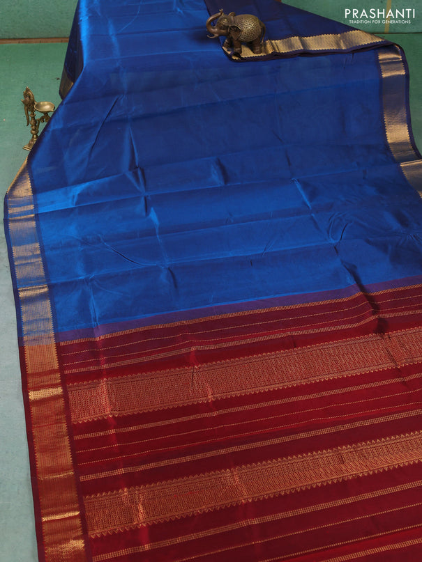 Silk cotton saree peacock blue and maroon with plain body and temple zari woven border