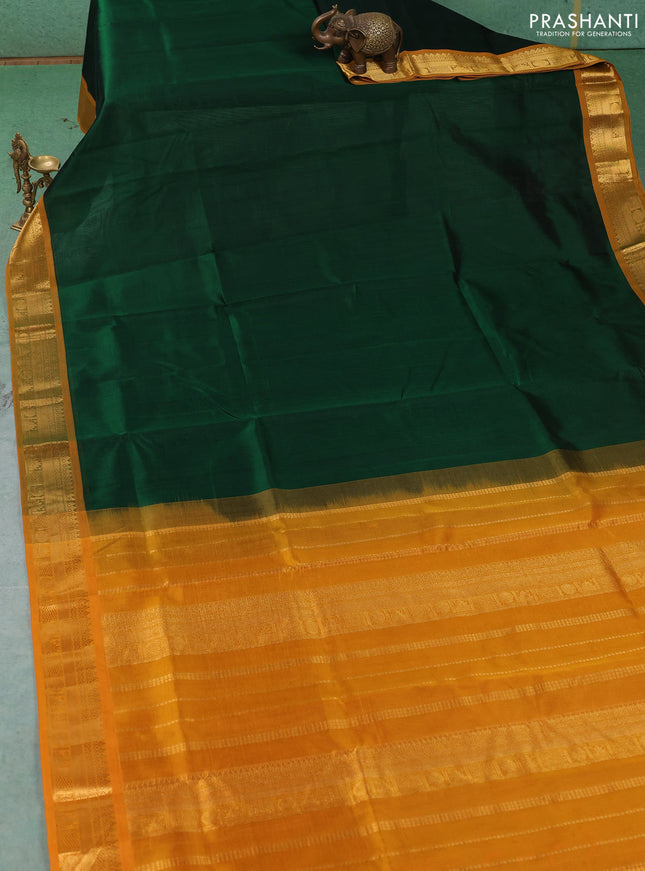 Silk cotton saree bottle green and mustard yellow with plain body and temple zari woven border