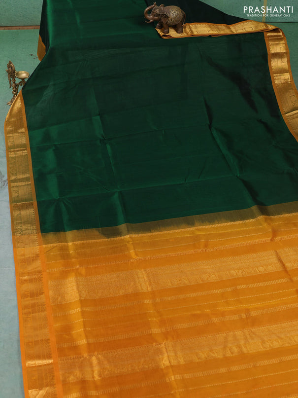Silk cotton saree bottle green and mustard yellow with plain body and temple zari woven border
