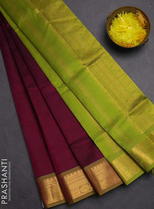 Silk cotton saree deep wine and light green with plain body and zari woven border
