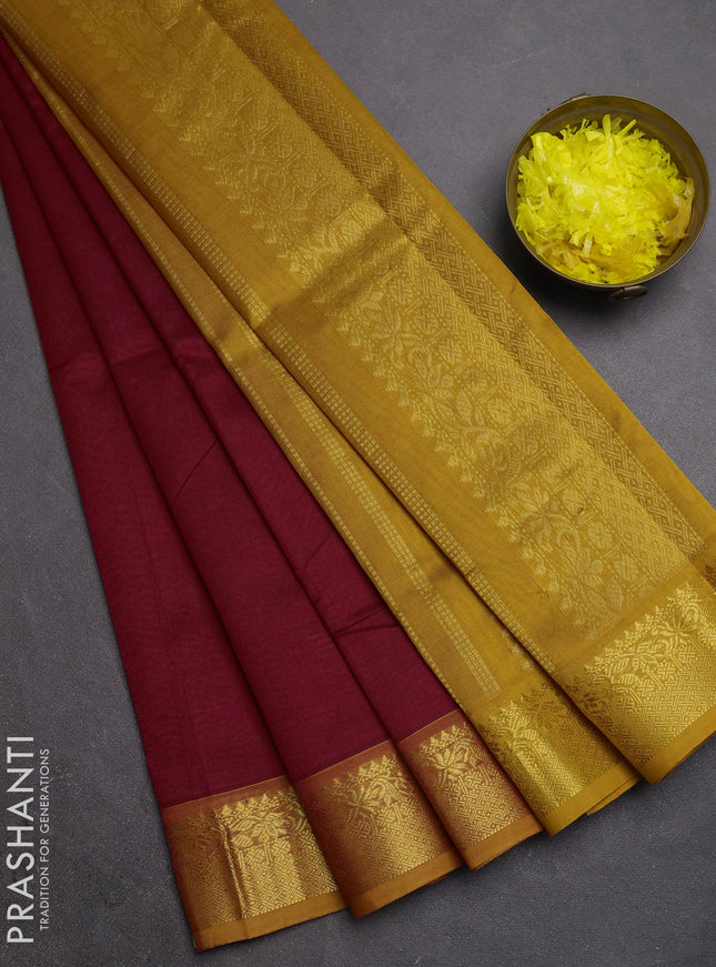 Silk cotton saree maroon and mustard yellow with plain body and zari woven border