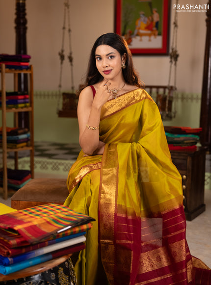 Silk cotton saree mustard green and maroon with plain body and zari woven border