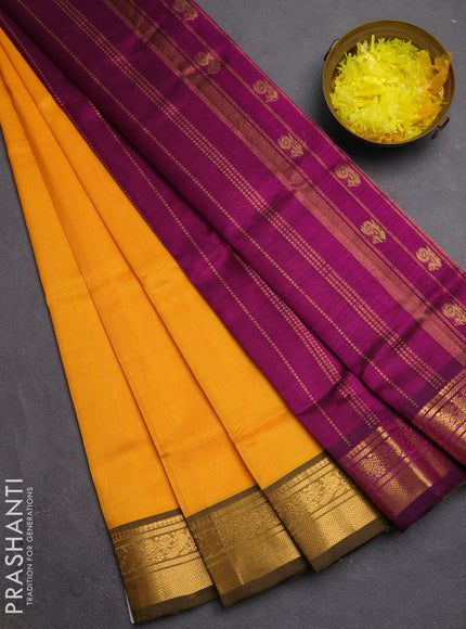 Silk cotton saree mango yellow and purple with plain body and zari woven border