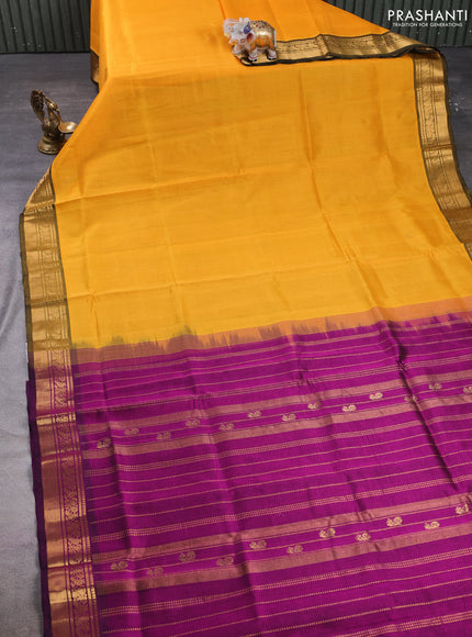 Silk cotton saree mango yellow and purple with plain body and zari woven border