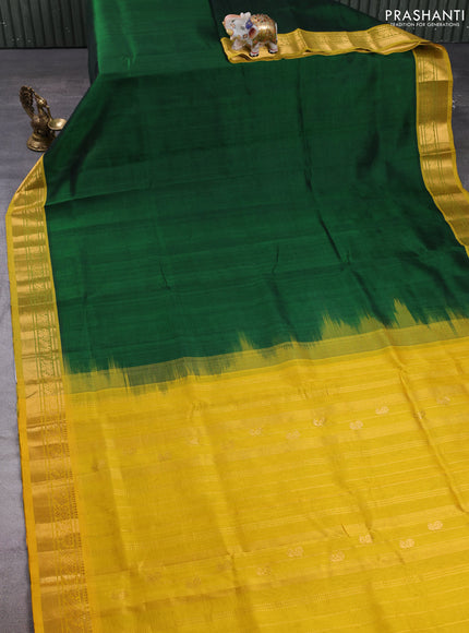 Silk cotton saree bottle green and mustard yellow with plain body and zari woven border