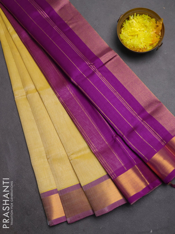Silk cotton saree pale yellow and purple with plain body and zari woven border