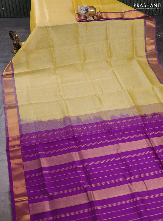 Silk cotton saree pale yellow and purple with plain body and zari woven border